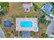 Aerial view of community pool, playground, and basketball court with lush greenery at 4387 Heartwood Ln., Myrtle Beach, SC 29579