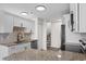 Open kitchen with stainless appliances, granite countertops, white cabinetry and easy access to the staircase at 4387 Heartwood Ln., Myrtle Beach, SC 29579