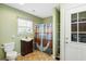 Nautical bathroom features a dark wood vanity, anchor shower curtain, and natural light from the window at 450 Deer Spring Loop, Georgetown, SC 29440