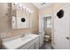 Neutral bathroom featuring a single sink vanity, mirror with lights, and an adjoining toilet room at 450 Deer Spring Loop, Georgetown, SC 29440