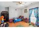 A bedroom, with colorful decor, hardwood floors, and natural light from window at 450 Deer Spring Loop, Georgetown, SC 29440
