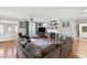 Spacious living room with hardwood floors, a decorative fireplace, large windows, and a comfortable sectional sofa at 450 Deer Spring Loop, Georgetown, SC 29440