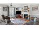 Cozy living room featuring hardwood floors, a decorative fireplace, and a large window with natural light at 450 Deer Spring Loop, Georgetown, SC 29440