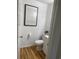 Powder room with Picasso art, a new toilet and new flooring at 4637 Lightkeepers Way # 4-A, Little River, SC 29566