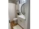 Bathroom with a white vanity, white cabinet and a round mirror at 4637 Lightkeepers Way # 4-A, Little River, SC 29566