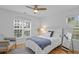 Bright bedroom with a ceiling fan, a gray chair and plenty of natural light at 4637 Lightkeepers Way # 4-A, Little River, SC 29566