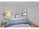 Bright bedroom featuring white walls, wood floors and a full size bed with blue accents at 4637 Lightkeepers Way # 4-A, Little River, SC 29566