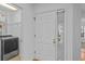 Hallway view showcasing the front door, laundry area and beautiful wood floors at 4637 Lightkeepers Way # 4-A, Little River, SC 29566