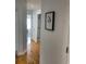 Hallway with wood floors and neutral walls leading to bedrooms and bathroom at 4637 Lightkeepers Way # 4-A, Little River, SC 29566
