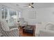 Bright and airy living room with hardwood floors, ceiling fan, two decorative armchairs, and a comfortable sofa at 4637 Lightkeepers Way # 4-A, Little River, SC 29566