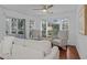 Bright living room with hardwood floors, large windows, two decorative armchairs, and a comfortable sofa at 4637 Lightkeepers Way # 4-A, Little River, SC 29566