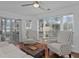 Bright living room with hardwood floors, sliding doors to screened porch, and a comfortable sofa at 4637 Lightkeepers Way # 4-A, Little River, SC 29566