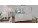 Bright living room detail with hardwood floors, window views, and a comfortable sofa at 4637 Lightkeepers Way # 4-A, Little River, SC 29566