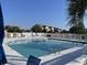 Inviting community pool with lounge chairs, framed by a secure, white picket fence at 4637 Lightkeepers Way # 4-A, Little River, SC 29566
