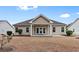 Back exterior view of home with a covered patio and a well-manicured lawn at 494 Battey Dr., Myrtle Beach, SC 29588
