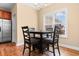 Bright dining area featuring hardwood floors, modern lighting, and a dining table next to the kitchen at 494 Battey Dr., Myrtle Beach, SC 29588