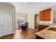 Dining area filled with sunlight, hardwood floors, dining table, and wood cabinets at 494 Battey Dr., Myrtle Beach, SC 29588
