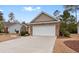 Front exterior view of the home with a spacious driveway and landscaped yard at 494 Battey Dr., Myrtle Beach, SC 29588