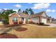 Inviting one-story home featuring a well-maintained lawn, brick accents and a sidewalk leading to the front door at 494 Battey Dr., Myrtle Beach, SC 29588
