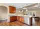 Well-lit kitchen featuring hardwood floors, granite counters and stainless steel dishwasher with view into the living area at 494 Battey Dr., Myrtle Beach, SC 29588