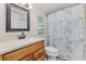 Bathroom features a stylish vanity, toilet, framed mirror, and coordinated paisley-themed shower curtain at 501 Maison Dr. # F-1, Myrtle Beach, SC 29572