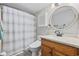 Bathroom features a wooden vanity, round mirror, and shower/tub combination at 501 Maison Dr. # F-1, Myrtle Beach, SC 29572