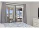 Bedroom showcasing sliding glass door access to the outdoor patio with seating at 501 Maison Dr. # F-1, Myrtle Beach, SC 29572
