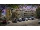 Exterior view of multi-level condo building with cars parked in front and pink sky at 501 Maison Dr. # F-1, Myrtle Beach, SC 29572