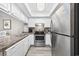 Efficient kitchen features stainless steel appliances, white cabinets, and granite countertops at 501 Maison Dr. # F-1, Myrtle Beach, SC 29572