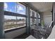 Enclosed outdoor patio featuring chairs, a table, and views of the marsh at 501 Maison Dr. # F-1, Myrtle Beach, SC 29572