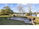 An outdoor picnic area has several tables and grills with a lake in the background surrounded by trees at 501 Maison Dr. # F-1, Myrtle Beach, SC 29572