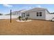 Backyard featuring a stone firepit area and screened in porch at 5064 Wavering Place Loop, Myrtle Beach, SC 29579