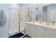 Bathroom featuring double sinks and a stand-up shower with white cabinets at 5064 Wavering Place Loop, Myrtle Beach, SC 29579
