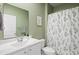 Bathroom with a vanity, modern fixtures, and a shower with a leaf-patterned curtain at 5064 Wavering Place Loop, Myrtle Beach, SC 29579