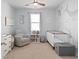 Calming Bedroom with whale wall art, glider, crib, and ample natural light at 5064 Wavering Place Loop, Myrtle Beach, SC 29579
