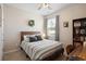 Bedroom featuring a comfortable bed, modern decor, and a ceiling fan at 5064 Wavering Place Loop, Myrtle Beach, SC 29579
