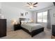 Comfortable bedroom featuring a ceiling fan and a bed with decorative pillows at 5064 Wavering Place Loop, Myrtle Beach, SC 29579