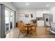 Cozy dining area adjacent to the kitchen with a round table, seating for four, and sliding glass doors to the backyard at 5064 Wavering Place Loop, Myrtle Beach, SC 29579