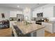 Well-equipped kitchen featuring an island with barstool seating, stainless steel appliances, and ample cabinet space at 5064 Wavering Place Loop, Myrtle Beach, SC 29579