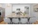 Stylish kitchen island with granite countertops, seating for four, and stainless steel appliances at 5064 Wavering Place Loop, Myrtle Beach, SC 29579