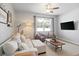 Bright living room with a comfortable sectional sofa, modern ceiling fan and stylish decor at 5064 Wavering Place Loop, Myrtle Beach, SC 29579