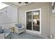 Cozy covered patio with cushioned seating and a view of the backyard at 5064 Wavering Place Loop, Myrtle Beach, SC 29579