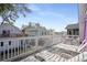 Inviting back deck with lounge seating, dining table, and neighborhood views, perfect for outdoor entertaining at 508-B Rosemary Ln., North Myrtle Beach, SC 29582