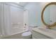 Bright bathroom with a shower and tub combo, classic fixtures, and a decorative oval mirror above the sink at 508-B Rosemary Ln., North Myrtle Beach, SC 29582