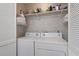 Functional laundry area equipped with a washer and dryer, and shelving for storage of laundry essentials at 508-B Rosemary Ln., North Myrtle Beach, SC 29582