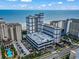 Aerial view features ocean views, parking garage, and manicured landscapes at 5308 N Ocean Blvd. # 1003, Myrtle Beach, SC 29577