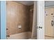 Bathroom tub and shower combination with tile and white shower curtain at 5308 N Ocean Blvd. # 1003, Myrtle Beach, SC 29577
