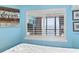 Bedroom featuring a window with plantation shutters and a view of the ocean at 5308 N Ocean Blvd. # 1003, Myrtle Beach, SC 29577