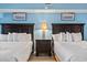 Bright bedroom featuring two queen beds, dark wood furniture, and soft, white bedding at 5308 N Ocean Blvd. # 1003, Myrtle Beach, SC 29577