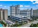 Aerial view of a resort with a multi-level parking garage and tropical landscaping at 5308 N Ocean Blvd. # 1003, Myrtle Beach, SC 29577